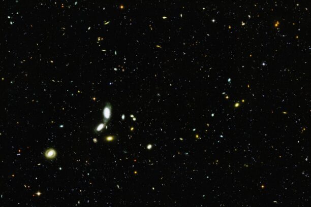 An image of distant stars and galaxies, from article "My psychedelic spirituality paradox"