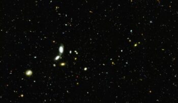 An image of distant stars and galaxies, from article "My psychedelic spirituality paradox"