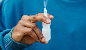 Holding a nasal spray, for article on prehospital stroke nasal spray
