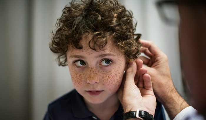 Child getting hearing test, for article on gene therapy for deafness