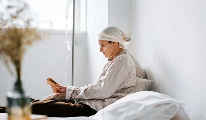 Cancer patient reading a book, for article on pre-surgery immunotherapy