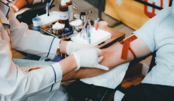 Man getting blood donation, for article on individualized risk assessment