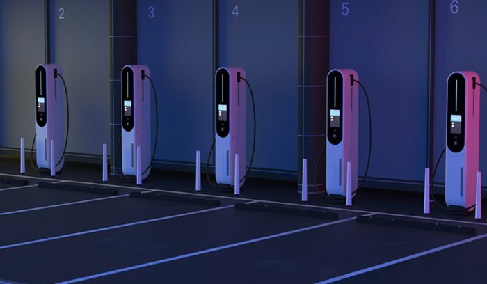 EV charging stations at night, for article on public EV charging ports