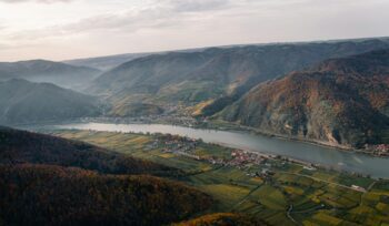River through a valley with houses on the riverside, for article on river barrier removals