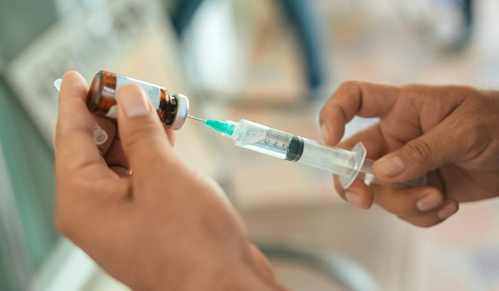 Filling vaccine syringe, for article on HPV vaccine