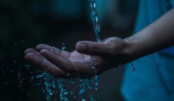Water falling on hand, for article on clean water access